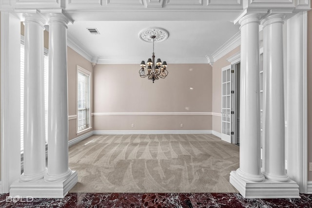 empty room featuring ornamental molding, carpet floors, and a chandelier