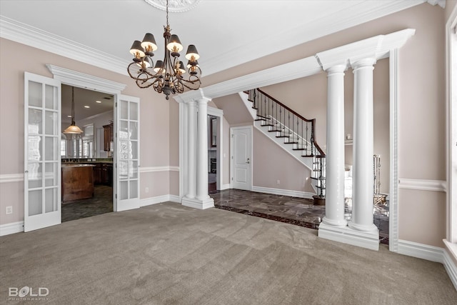 unfurnished dining area with dark carpet, french doors, ornamental molding, and an inviting chandelier