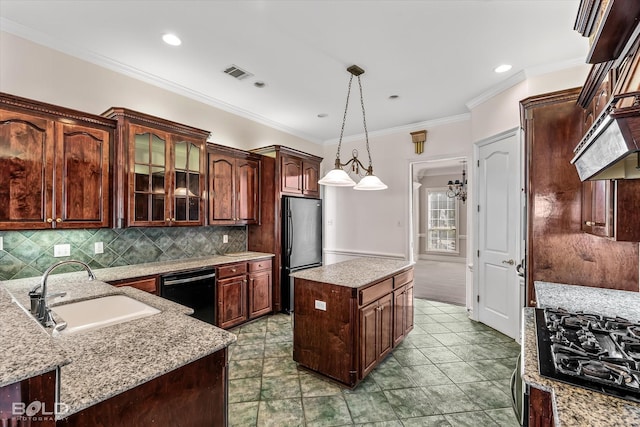 kitchen featuring a kitchen island, pendant lighting, sink, black appliances, and dark brown cabinets