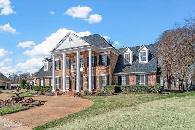 greek revival inspired property with a front lawn