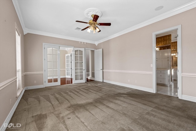 carpeted empty room with ceiling fan, ornamental molding, and french doors