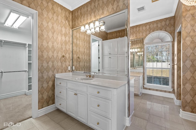 bathroom featuring tile patterned flooring, ornamental molding, and vanity