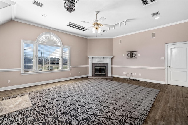 living room featuring dark hardwood / wood-style floors, ceiling fan, ornamental molding, and a fireplace