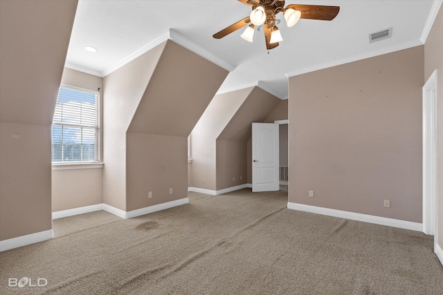 additional living space with ceiling fan, light colored carpet, and vaulted ceiling