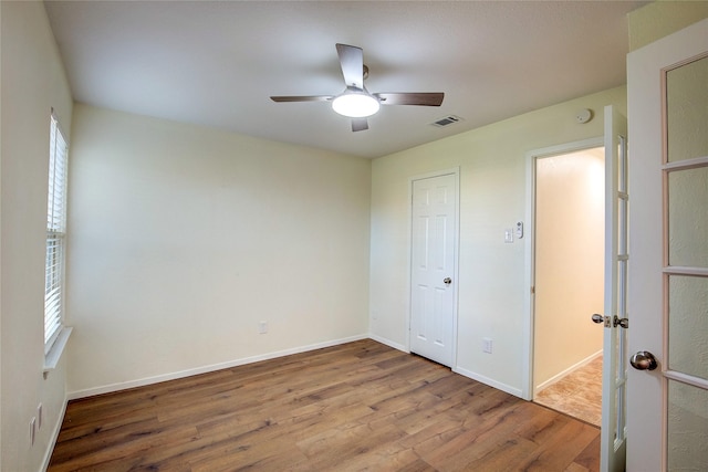 unfurnished bedroom with ceiling fan and light hardwood / wood-style floors