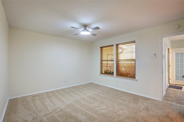 unfurnished room with ceiling fan and light colored carpet