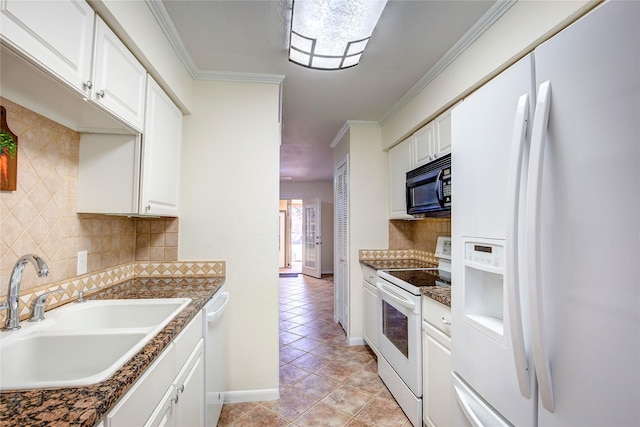 kitchen with sink, white appliances, white cabinetry, ornamental molding, and dark stone counters