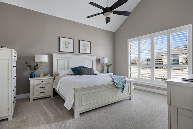 bedroom featuring ceiling fan, high vaulted ceiling, and light carpet