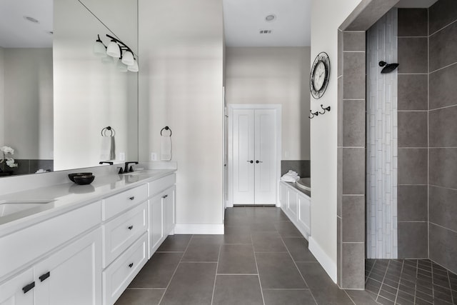 bathroom featuring tile patterned flooring, vanity, and shower with separate bathtub