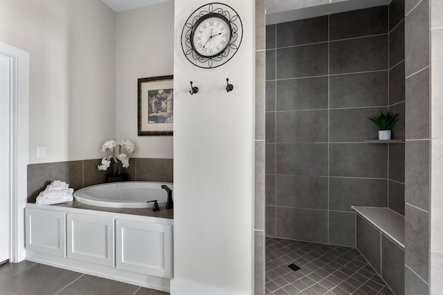 bathroom featuring tile patterned floors and independent shower and bath