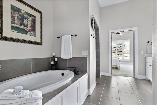 bathroom featuring tile patterned floors, vanity, and a washtub