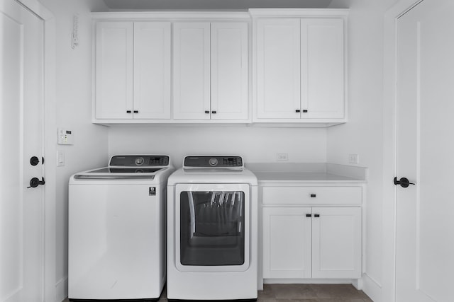 laundry area featuring cabinets, light tile patterned flooring, and washing machine and clothes dryer