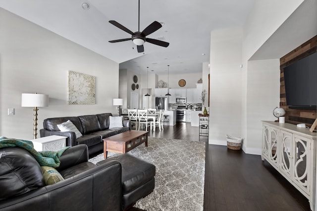 living room featuring dark wood-type flooring and ceiling fan