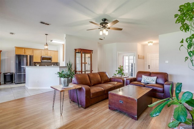 living room featuring ceiling fan and light wood-type flooring