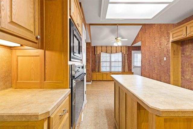 kitchen featuring black oven, ceiling fan, built in microwave, a kitchen island, and lofted ceiling