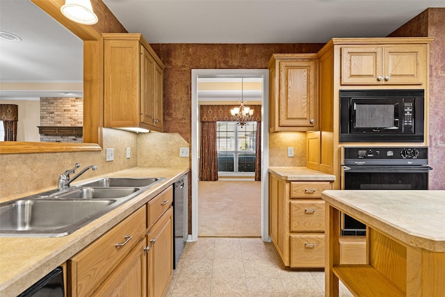 kitchen with sink, hanging light fixtures, tasteful backsplash, a chandelier, and black appliances