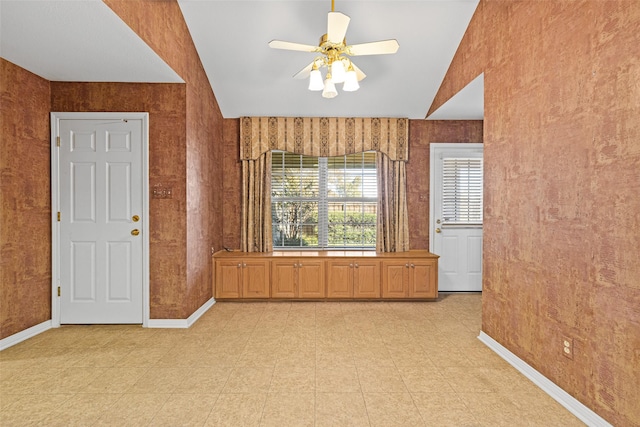 unfurnished room with vaulted ceiling and ceiling fan