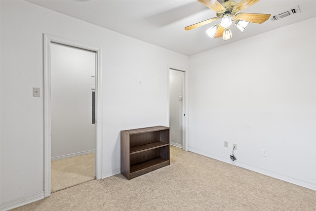 empty room with light colored carpet and ceiling fan