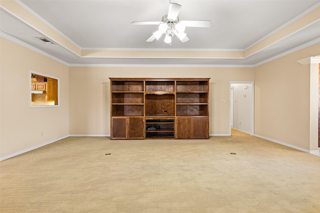 unfurnished living room featuring a raised ceiling, ceiling fan, and carpet floors