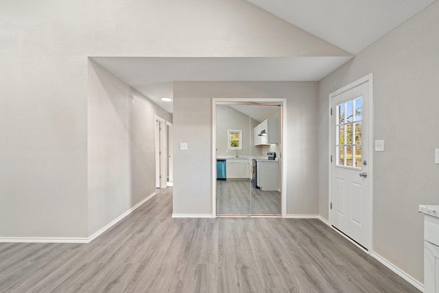 entrance foyer with light wood-type flooring and lofted ceiling