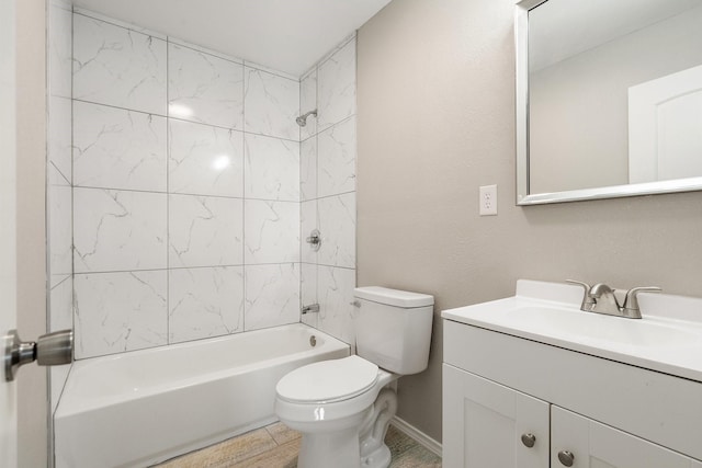 full bathroom with vanity, tiled shower / bath combo, and toilet