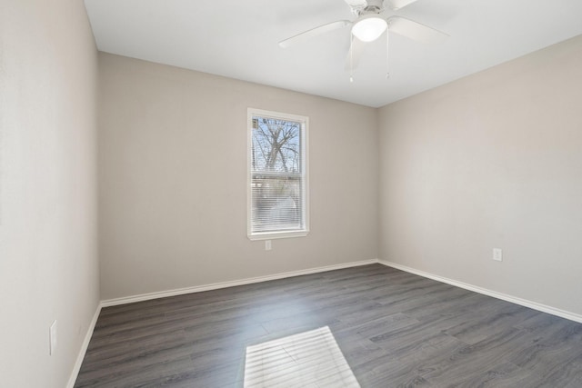 empty room featuring ceiling fan and dark wood-type flooring