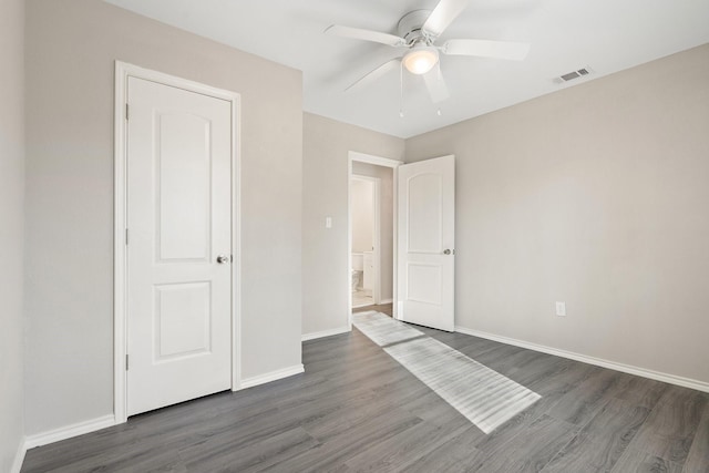 unfurnished bedroom featuring dark hardwood / wood-style flooring and ceiling fan