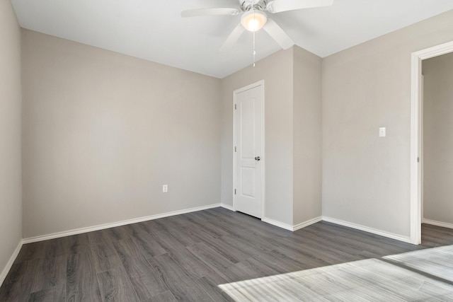 empty room featuring ceiling fan and dark wood-type flooring