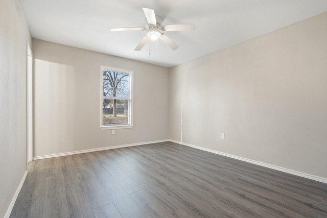 spare room with dark wood-type flooring and ceiling fan