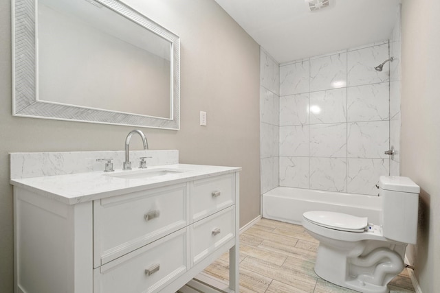 full bathroom with vanity, toilet, and tiled shower / bath