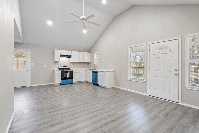 unfurnished living room featuring ceiling fan, plenty of natural light, high vaulted ceiling, and light wood-type flooring