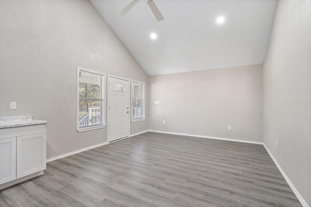 foyer featuring ceiling fan, light hardwood / wood-style flooring, and high vaulted ceiling