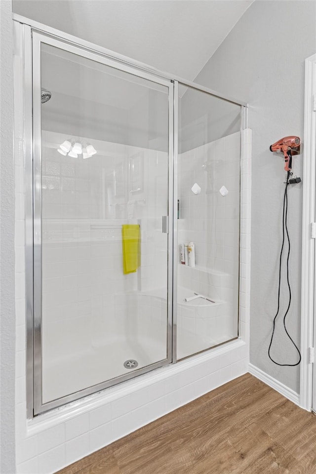 bathroom with hardwood / wood-style floors and walk in shower