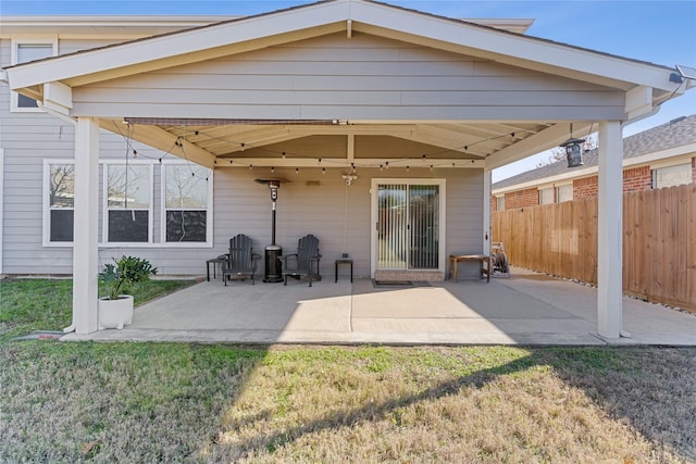 back of property with a lawn and a patio