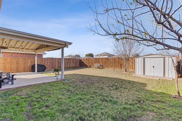 view of yard featuring a patio and a shed