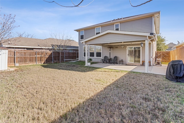 back of property with a yard and a patio