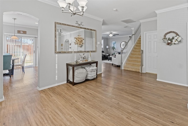 entrance foyer with crown molding, hardwood / wood-style floors, and ceiling fan with notable chandelier