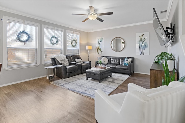 living room featuring hardwood / wood-style flooring, ceiling fan, and crown molding