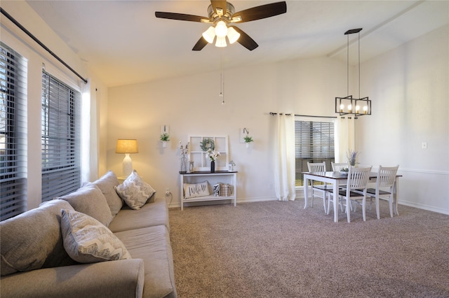 living room with lofted ceiling, ceiling fan with notable chandelier, a wealth of natural light, and carpet floors