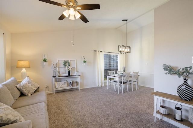 interior space with ceiling fan, vaulted ceiling, and carpet flooring