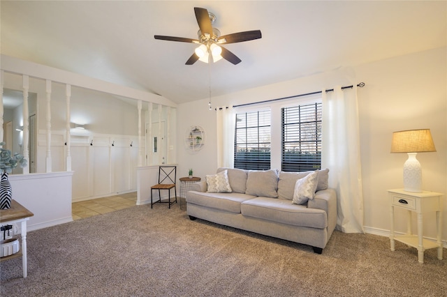 carpeted living room with lofted ceiling and ceiling fan