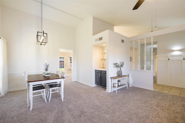 carpeted dining room featuring ceiling fan