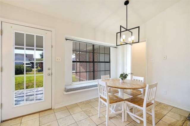 tiled dining area featuring a notable chandelier