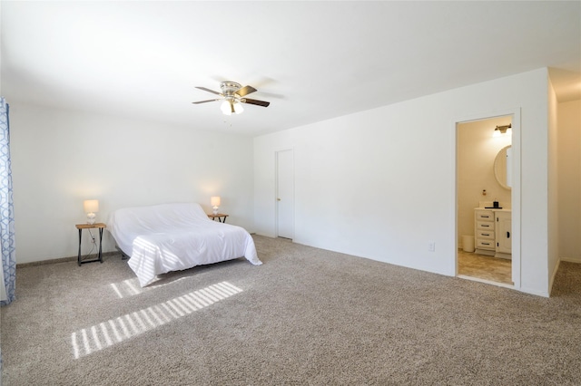 bedroom featuring ensuite bath, ceiling fan, and light carpet