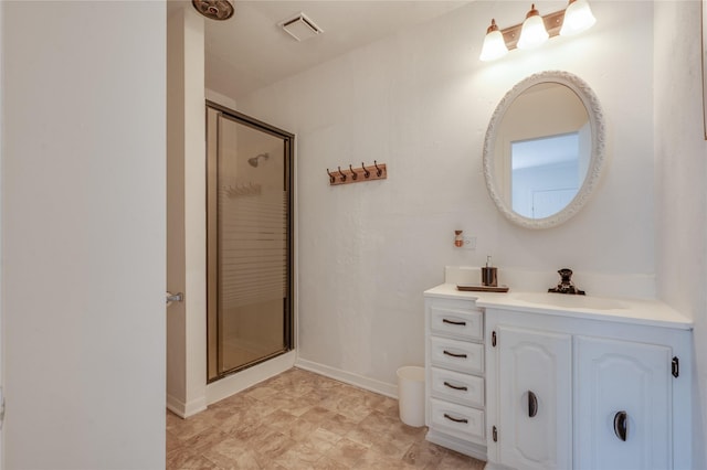 bathroom featuring vanity and a shower with shower door