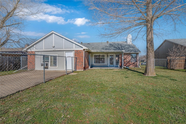 rear view of house with a lawn