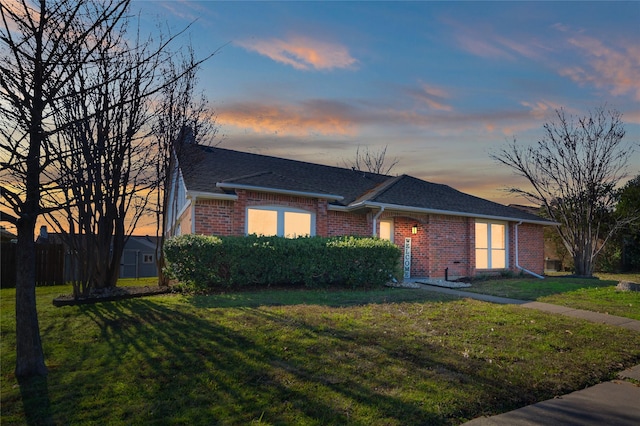 ranch-style home with a yard and central air condition unit