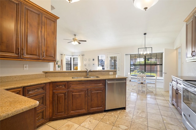 kitchen featuring stainless steel appliances, sink, light tile patterned floors, ceiling fan with notable chandelier, and hanging light fixtures