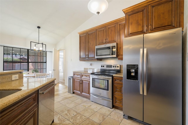 kitchen with vaulted ceiling, appliances with stainless steel finishes, light stone countertops, pendant lighting, and an inviting chandelier