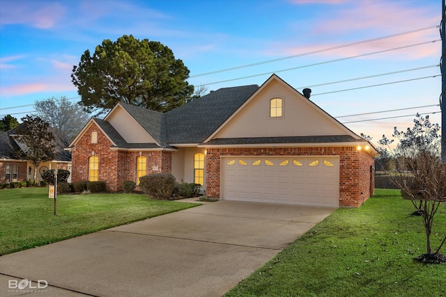 front facade with a garage and a lawn